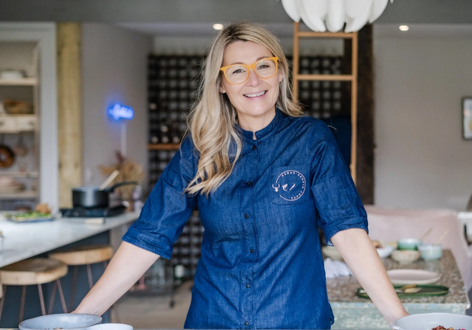 Image of Sarah Rankin in commercial kitchen in denim blue chef coat